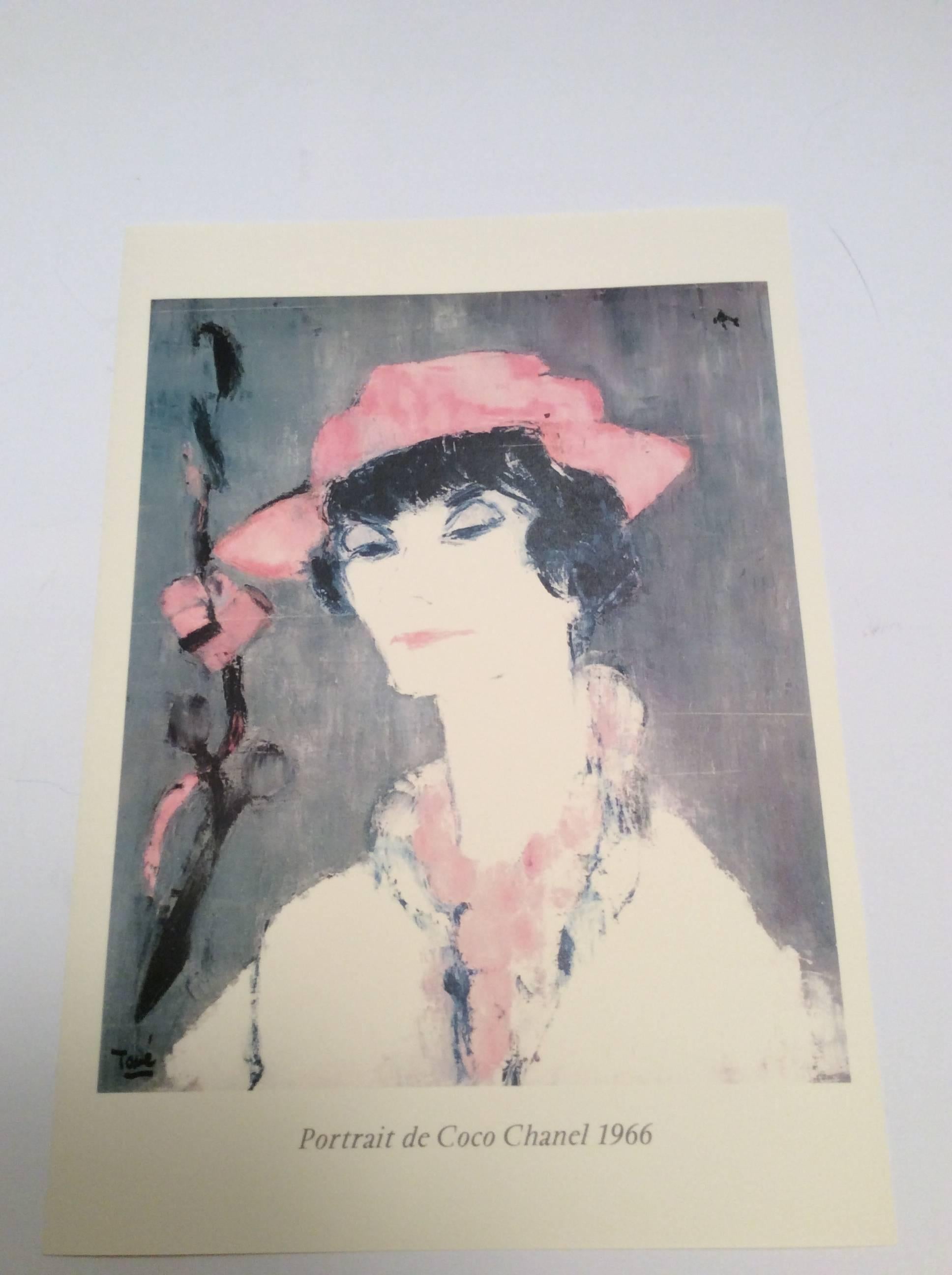 Here is a print of an oil portrait of Coco Chanel from the 1960's. The image is Coco dressed in white and pink against a charcoal background. A remarkable portrayal of the fashion icon. It is a print on professional art card stock printed in color.