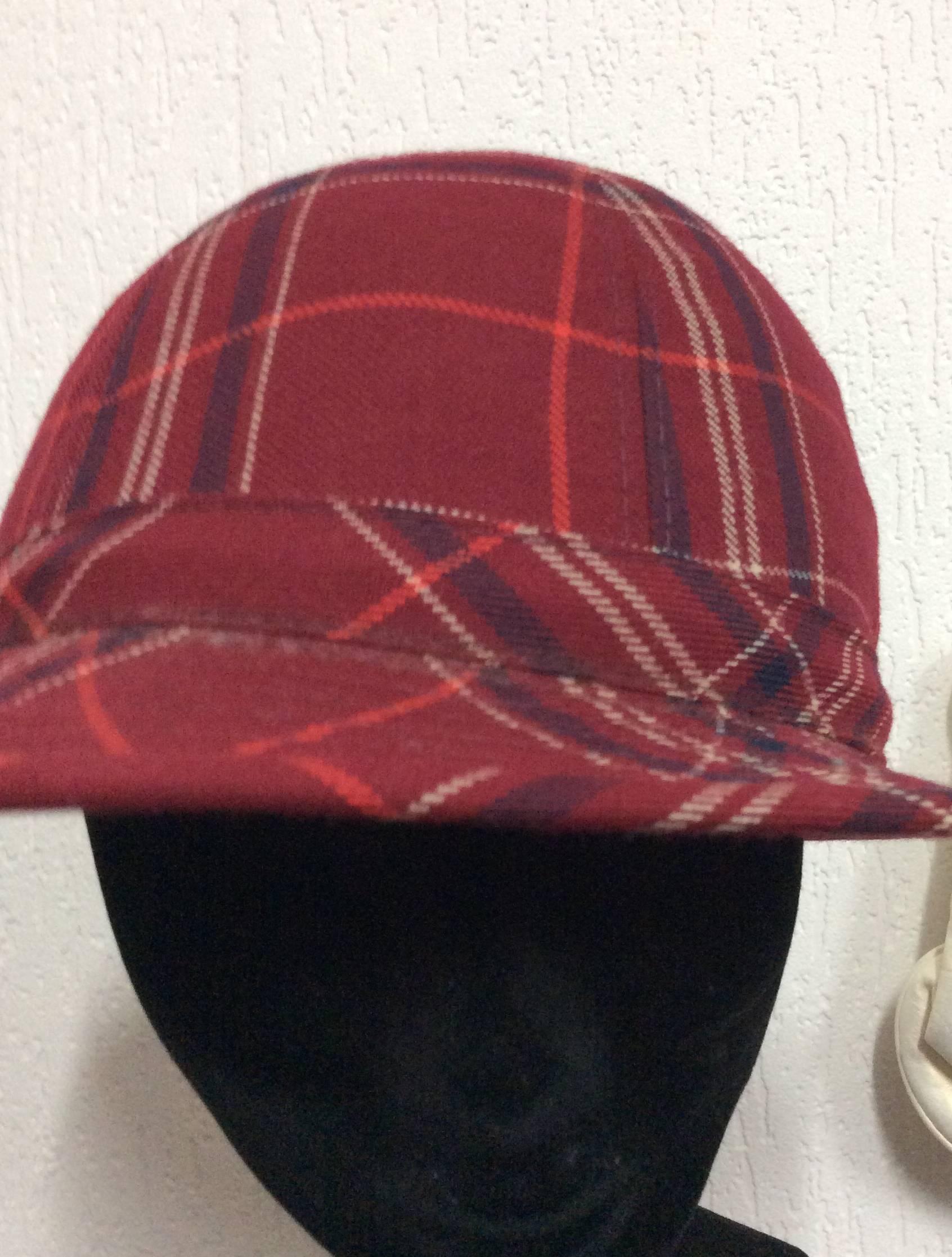 This adorable 1970's plaid hat has an inner circumference of 21 inches. The brim of the hat measures 1.75 inches. It is in excellent condition. The beautiful wool plaid has a combination of red, blue, white, and orange stripes. 