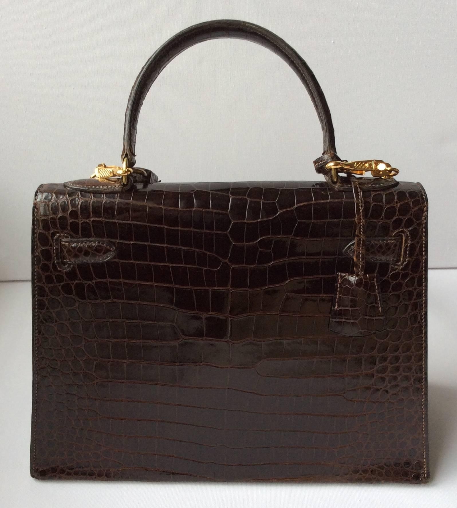 Presented here is an extremely rare brown crocodile Hermes kelly from the 1960's with shoulder strap which was added in the 1980's. The shoulder strap was purchased from Hermes in the 1980's. It was property of Sonia Rykiel, the famous french