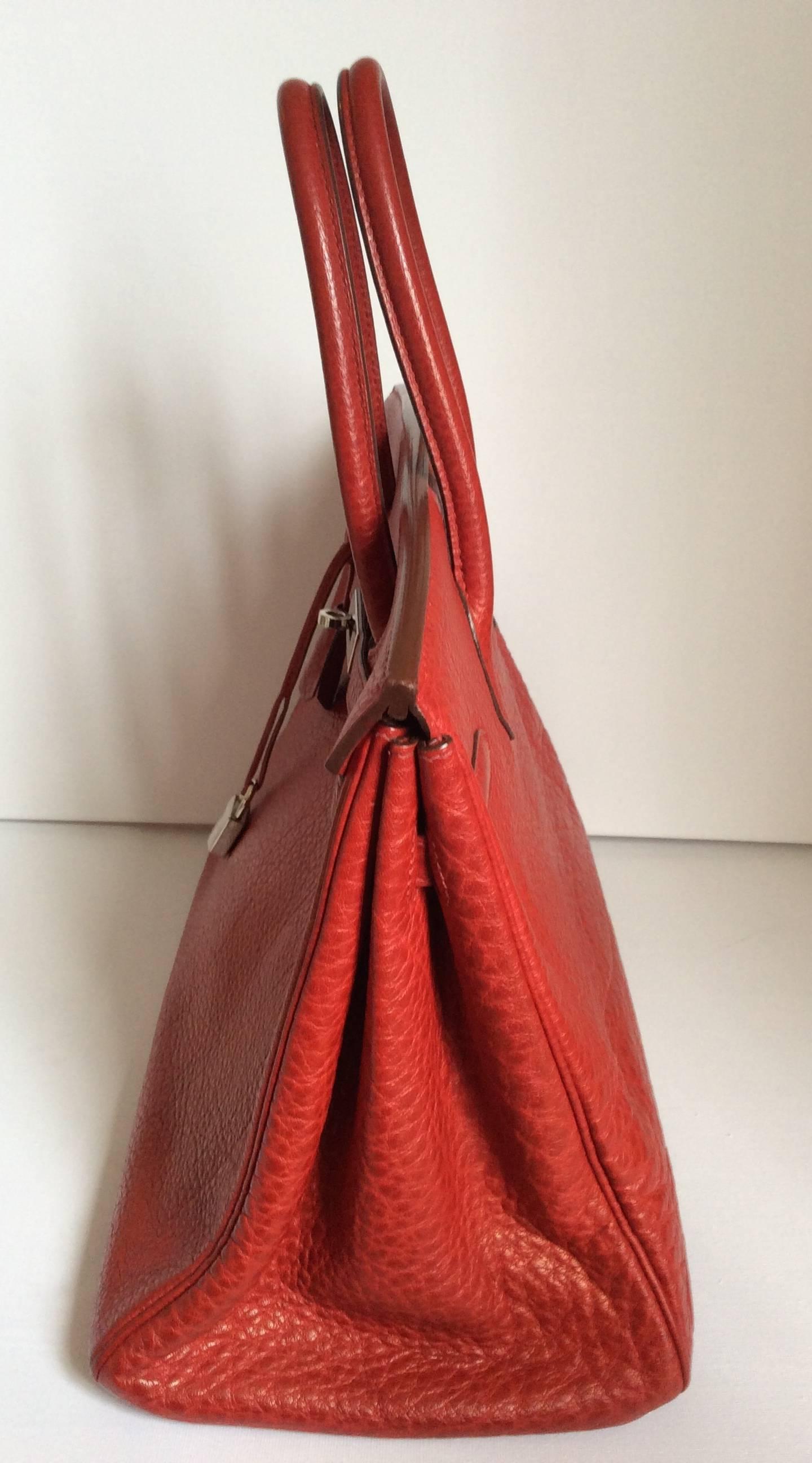 Presented here is a magnificent Hermes Birkin bag in red buffalo. The bag is a size 35 and is in near mint condition. This bag appears to have only been used a few times and probably was stored mostly in a closet for safe keeping. The bag is stamped