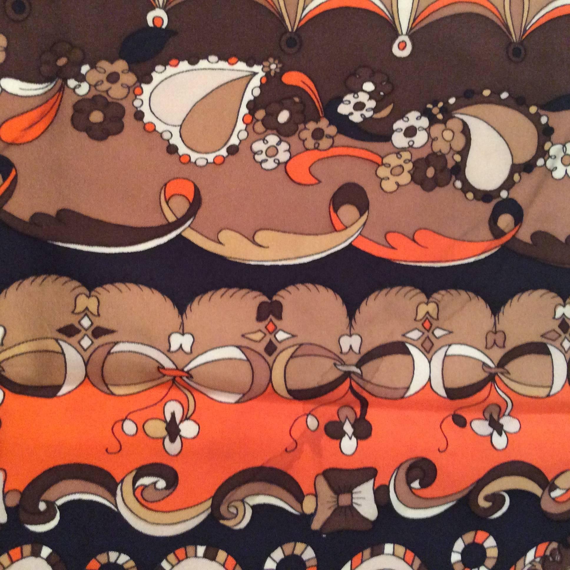 This rare Emilio Pucci Scarf from the 1970's is absolutely gorgeous. It is composed of colors of brown, black, orange, gray, and white. It is absolutely magnificent and is a very rare piece of Emilio Pucci history. The scarf is signed in the design