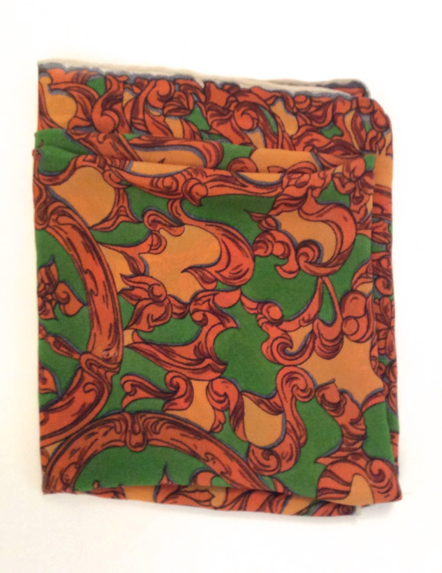 This Emilio Pucci scarf is made of 100% silk and is from the 1960's. It is an extremely rare scarf and its pattern is comprised of orange and green shades throughout the scarf. This particular scarf was from the 5th Avenue B. Altman Store in New