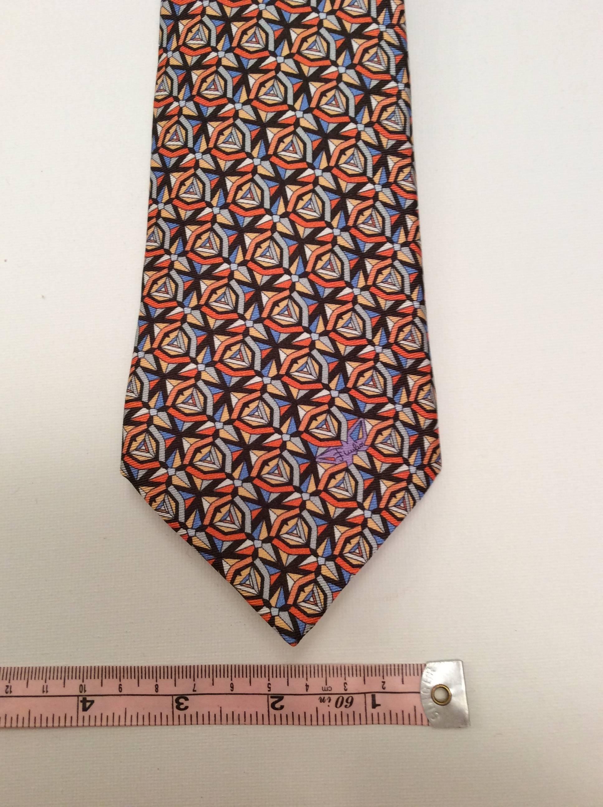 This Emilio Pucci necktie is made of 100% silk and is a clear example of the pure artistry exhibited by Emilio Pucci. Gorgeous rare necktie that is signed on the from throughout the pattern and on the back of the tie as well. Tie is in mint
