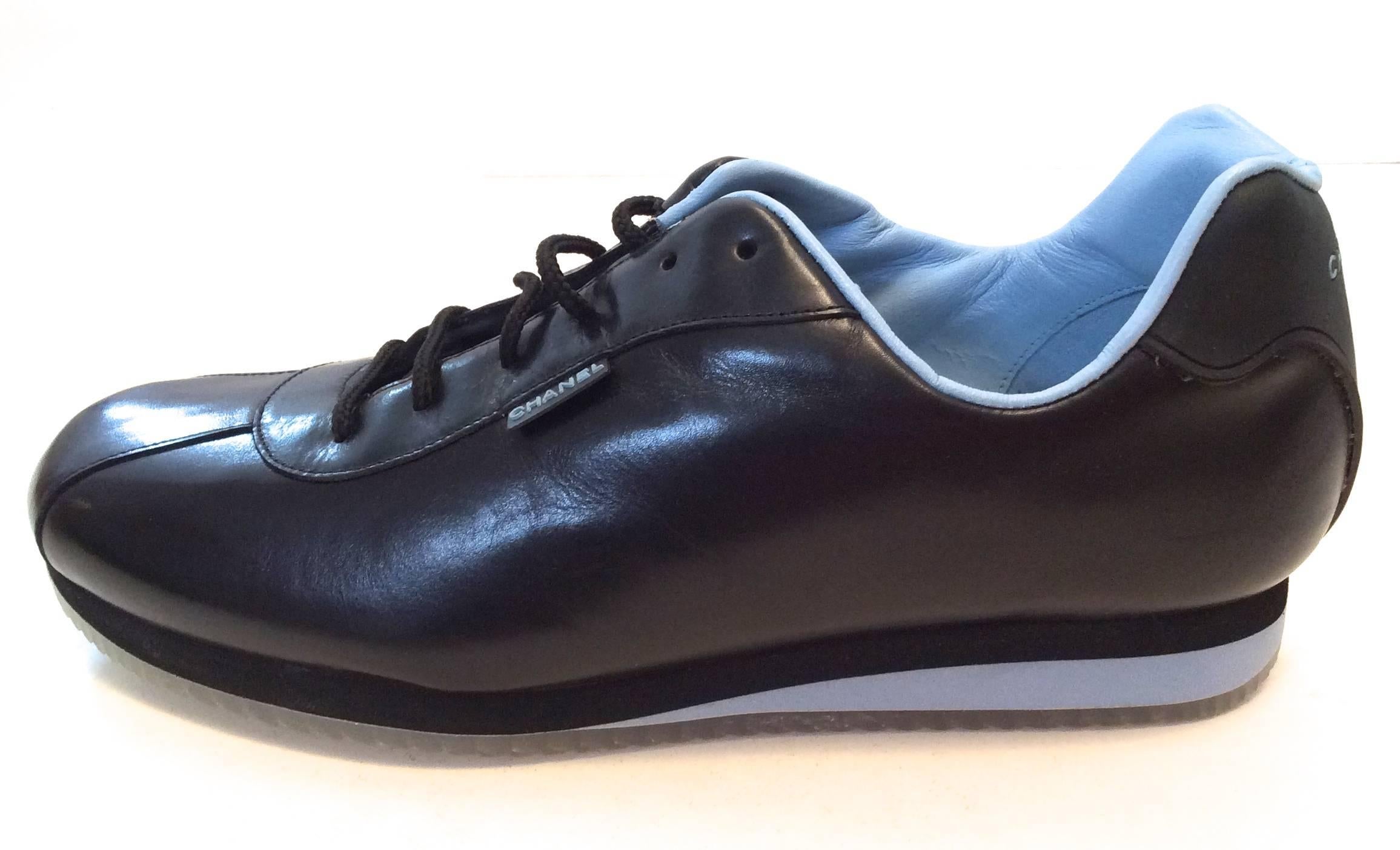New Chanel black sneakers that are size 35.5 They are a beautifully designed shoe with the CC branding on exterior of the shoe. They have a gridded lined sole and are signed throughout the body of the shoe. A rare and difficult shoe to find that