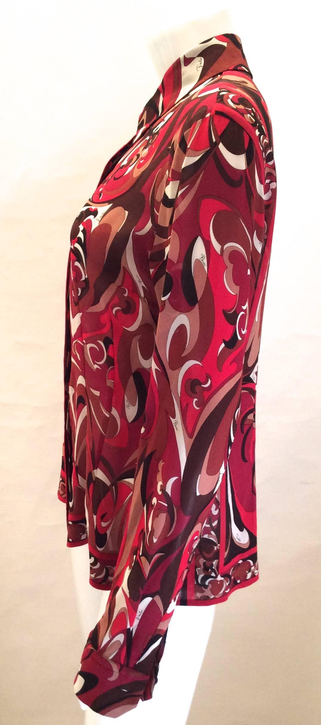 This beautiful Emilio Pucci Firenze red and black silk abstract print button down blouse is a size 10. It's like new in excellent condition with no significant flaws or signs of wear. The beautiful sleeves have the Pucci logo signed on them and