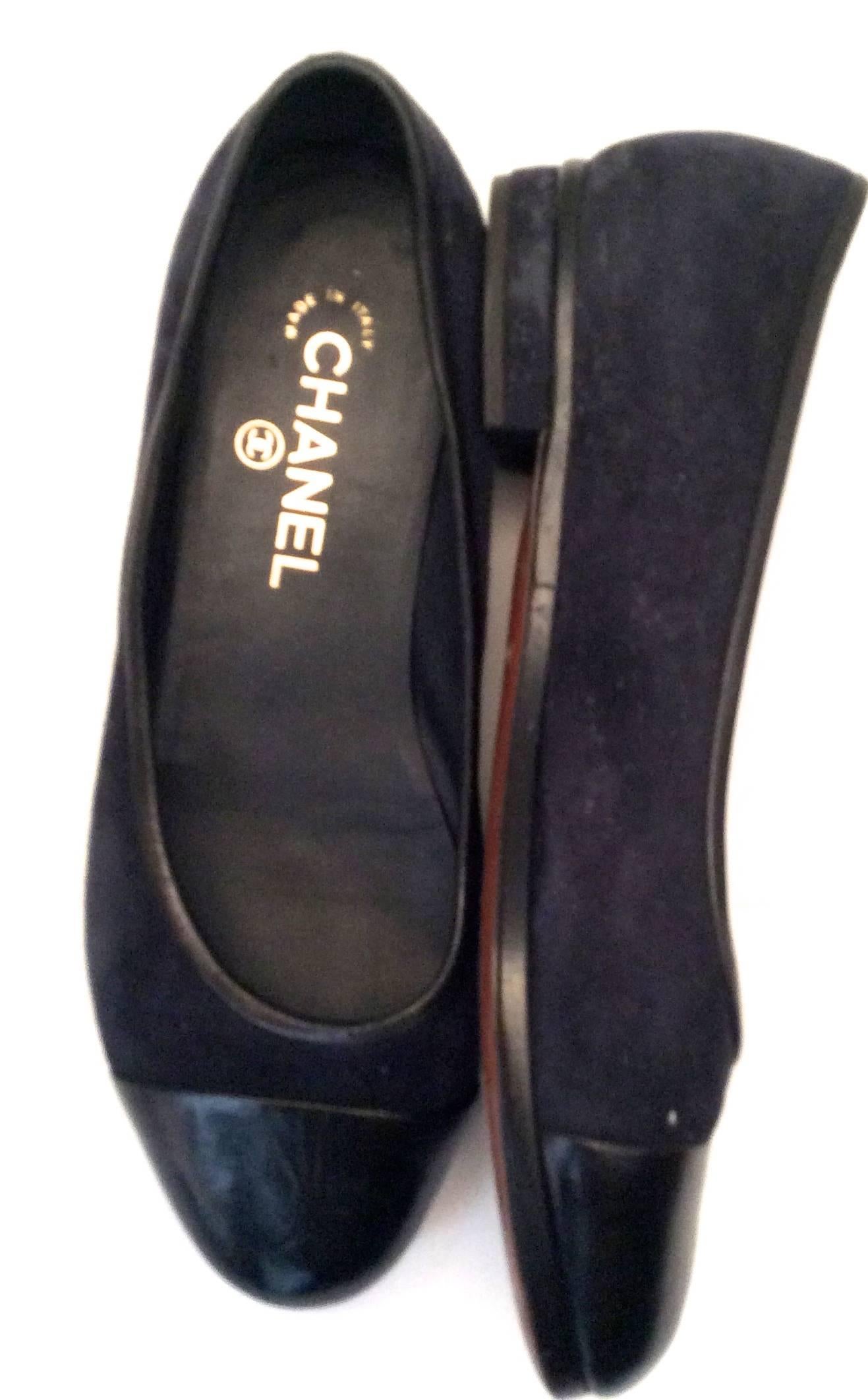 You are looking at a beautiful pair of Chanel ballerina flats. They are wonderful because they are more structured sole as you can see on the photographs. They are navy, suede with blue leather tips and black leather surrounding the opening of the