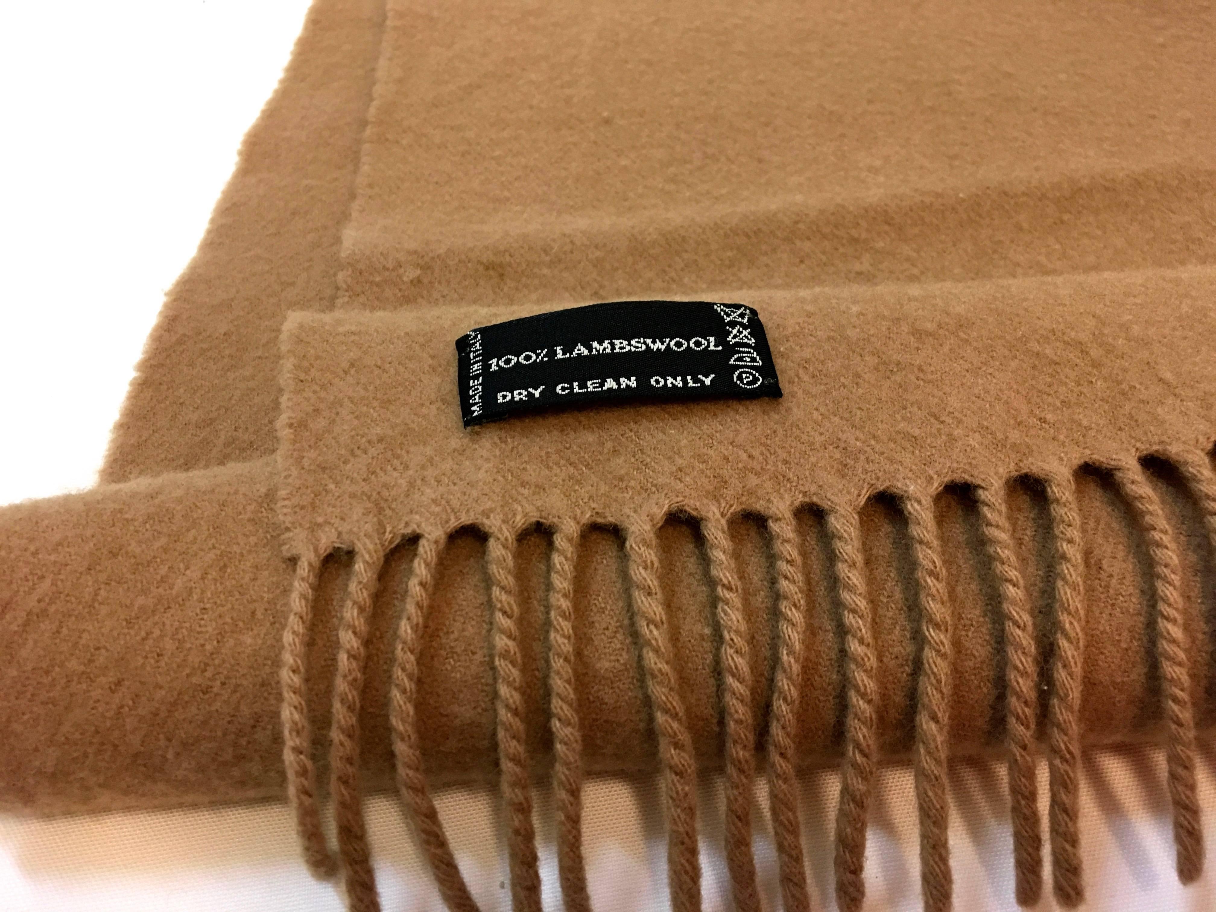 Presented here is a 1980's Courreges wool scarf. The scarf is brown and is embroidered with the iconic Courreges signature on the end of the scarf. The scarf is in very good condition with little signs of wear. Please see photographs. A good color