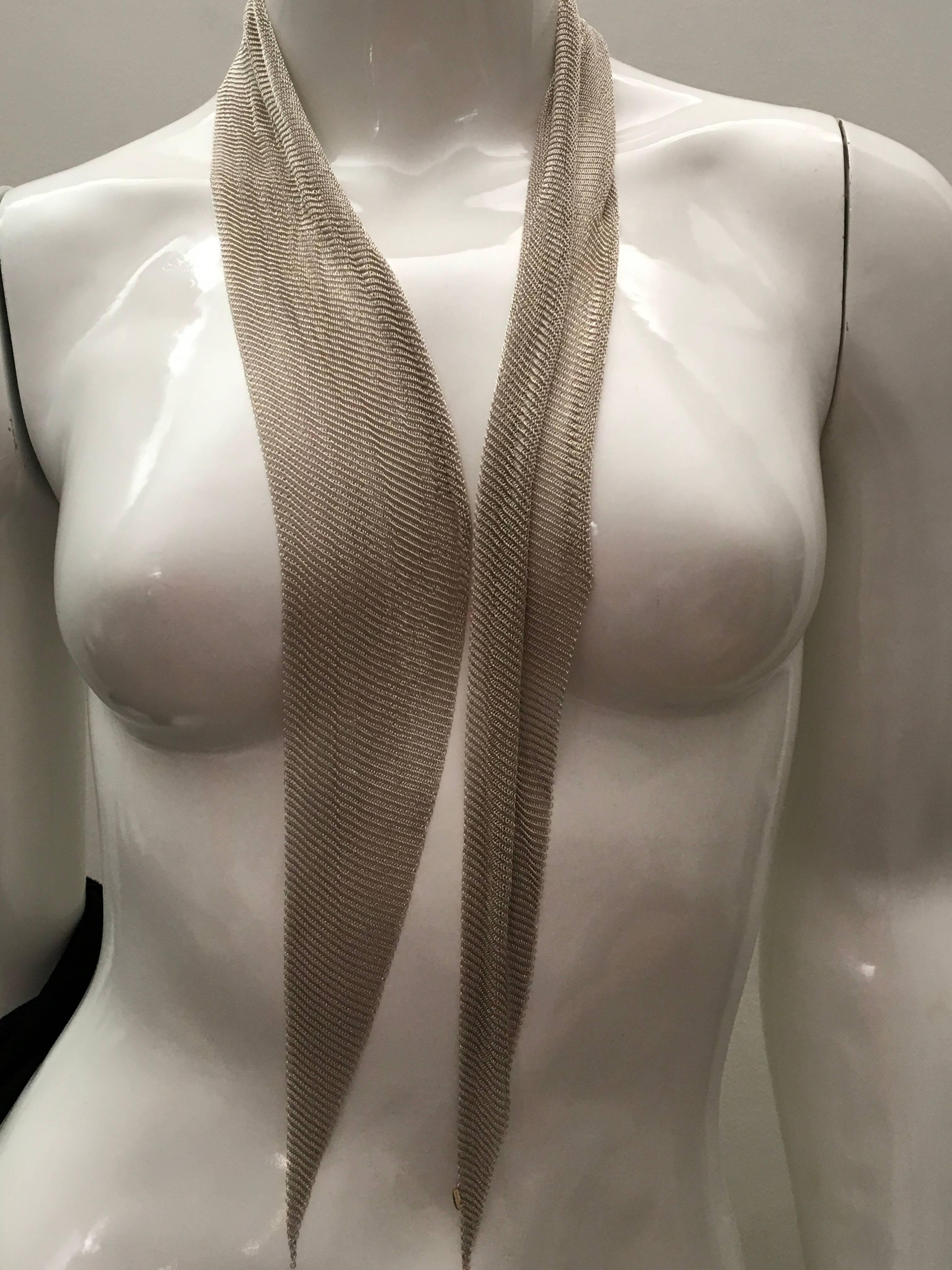 Presented here is a beautiful mesh scarf from Tiffany and Co. This magnificent mesh scarf has a total weight of 131 grams of sterling silver. The scarf measures 41.5 inches long and 5 inches wide at the center. The scarf is constructed of a very