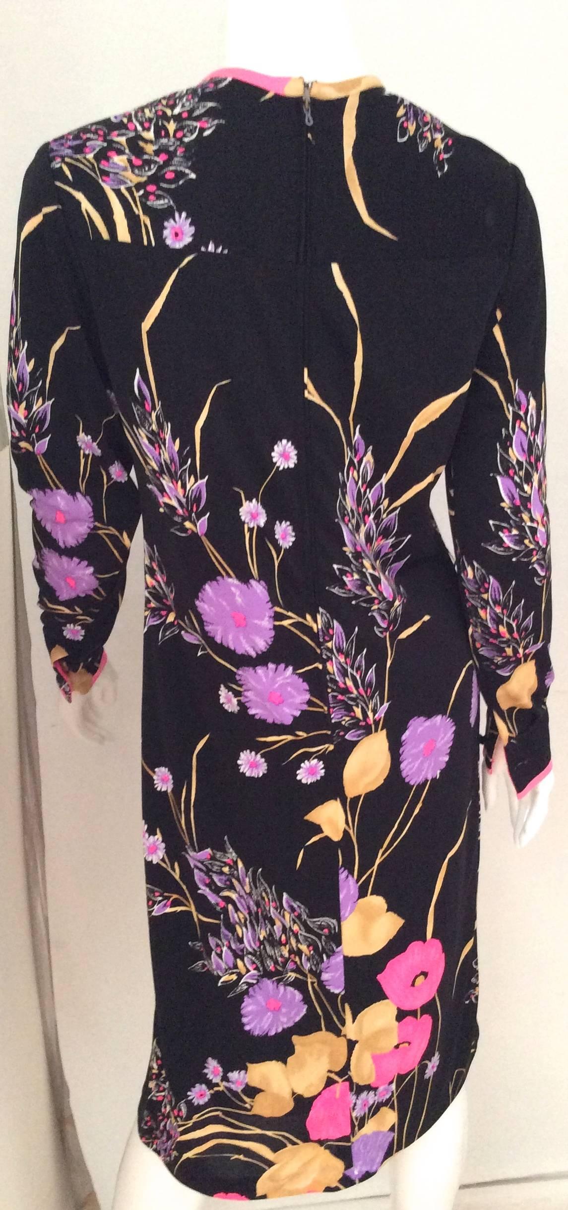 Beautiful black dress with electric color of floral designs consisting of hot pink, purple, gold, white, and lavender. Mint Condition. This beautiful Leonard dress fits approximately a size US 6. It is from the late 1960's. The shoulder measurement