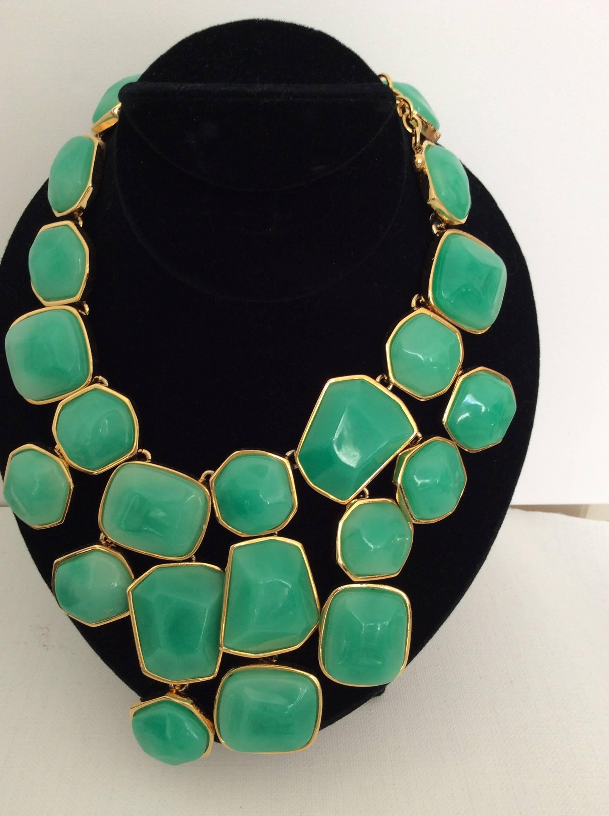 Kenneth J. Lane necklace with matching earring set. A gorgeous gold tone chain with an elaborate series of resin green shapes are inlayed into a remarkably engineered necklace. Truly a showpiece from Kenneth J. Lane. The back shows the elaborate