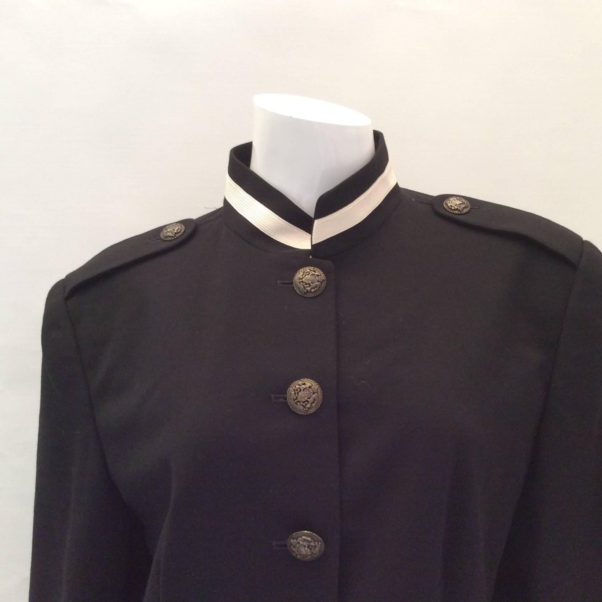 This jacket is from the late 1980's when Donna Karen exploded onto the fashion scene. Her second line, 'DNKY New York' was a fabulous success. This jacket is a black jacket with cream colored trim and black epaulette at the shoulders with beautiful