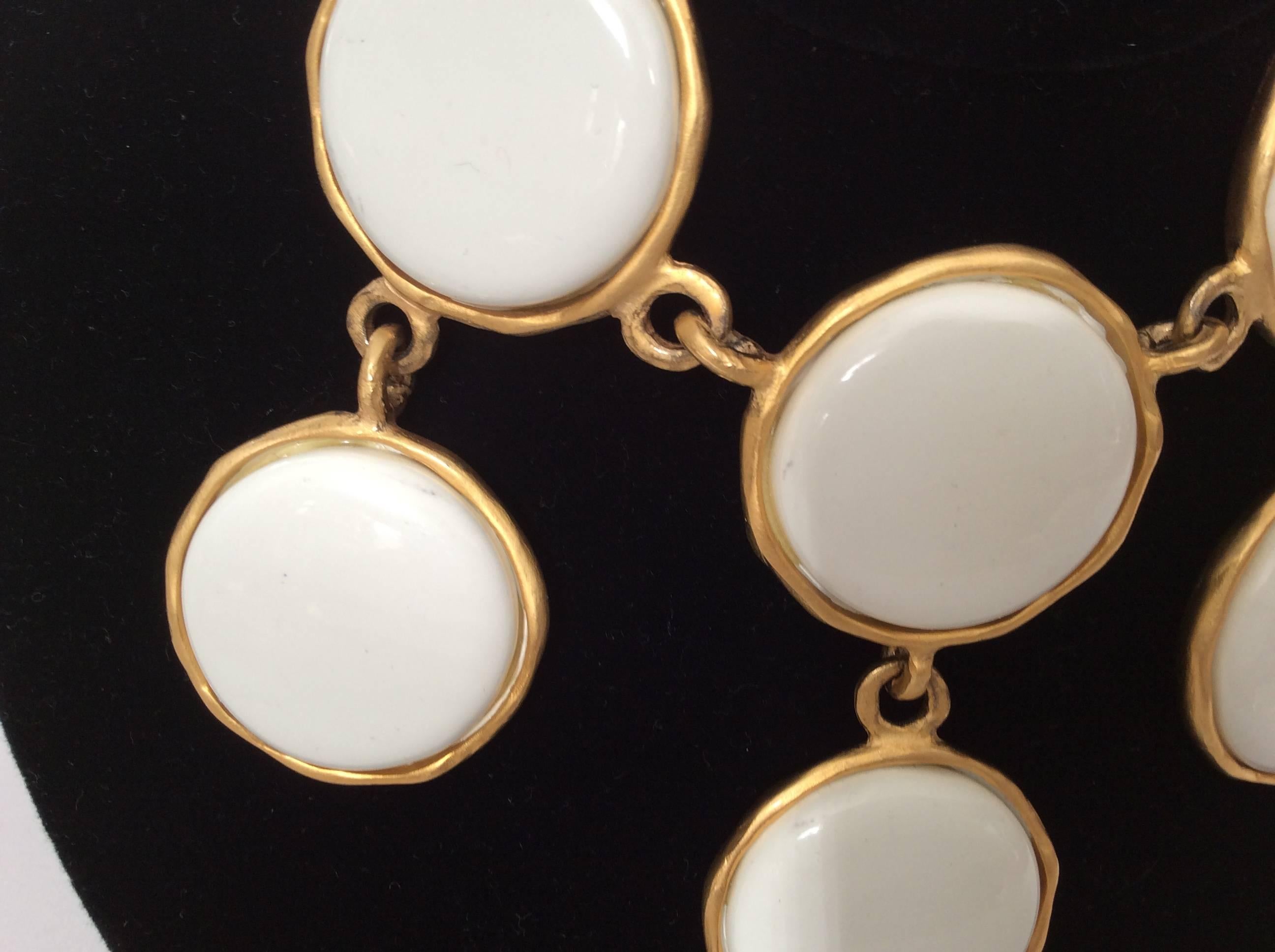Kenneth J. Lane white necklace with matching earrings set. Gorgeous necklace that is a gold tone chain adorned with a series of 6 white circular charm links. The necklace is from the 1980's and is a great addition to any jewelry collection. The