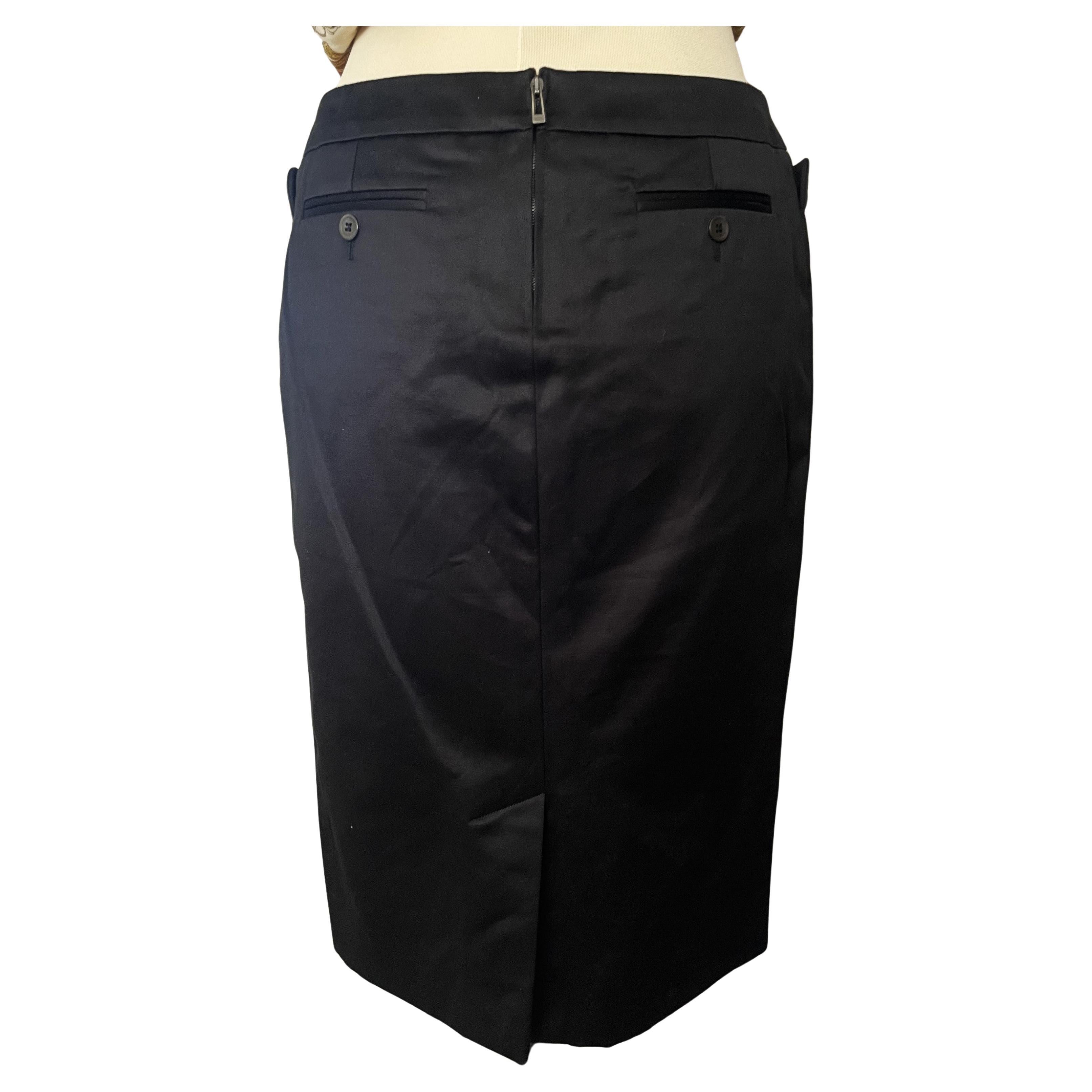Der Yves Saint Laurent Vintage 90s Black Sateen Classic Short Skirt with Pockets ist ein herausragendes Stück aus den berühmten 1990er Kollektionen von YSL. 
Dieser Rock zeichnet sich durch eine klassische Silhouette aus, die für ihren zeitlosen