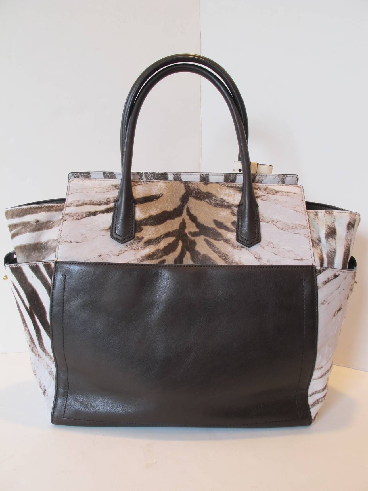 A structural large tote design in luxuriant zebra printed calf hair with leather trim. Dual leather carry handles, 6