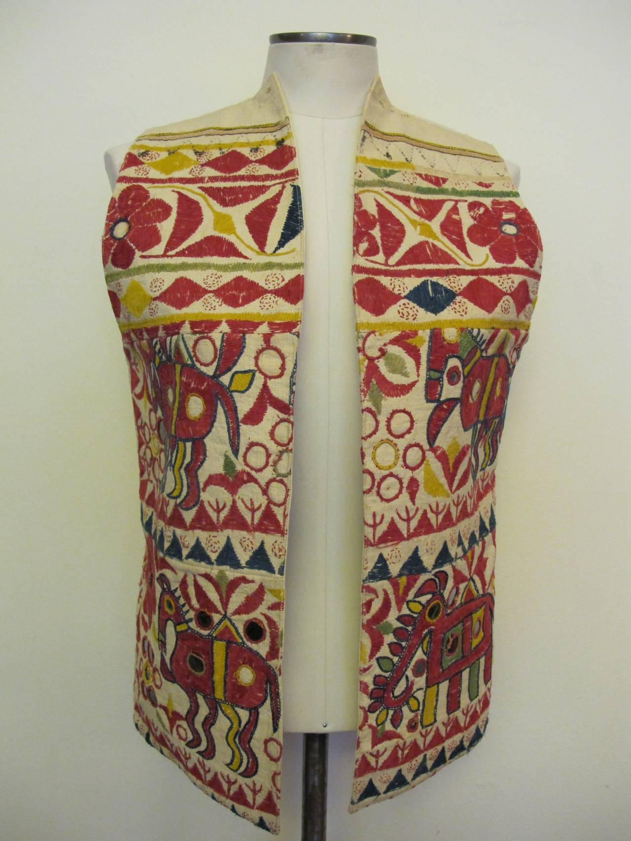 Brightly-Colored design of horizontal rows of flowers animals and geometric patterns against a neutral ground reminiscent of a Turkish Kilim creating this exciting vest. Collection of former fashion director of Saks Fifth Avenue. The designs on the