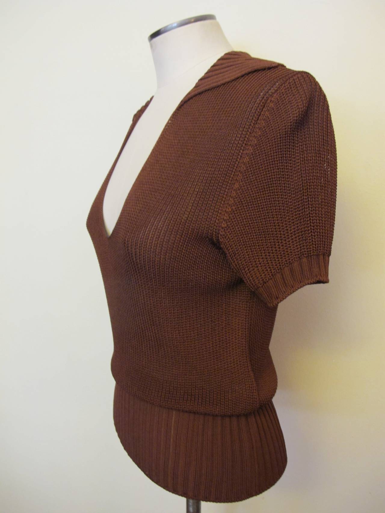 Chic Hermes Redwood Brown Knitted Sweater Blouse with short sleeves. Collar and V-Neck. Fabric Stretches and contours to figure. *Note back of Sweater. Sleeve length measures 7.5 inches. Shoulder to shoulder measures 15.5 inches. The bust measures