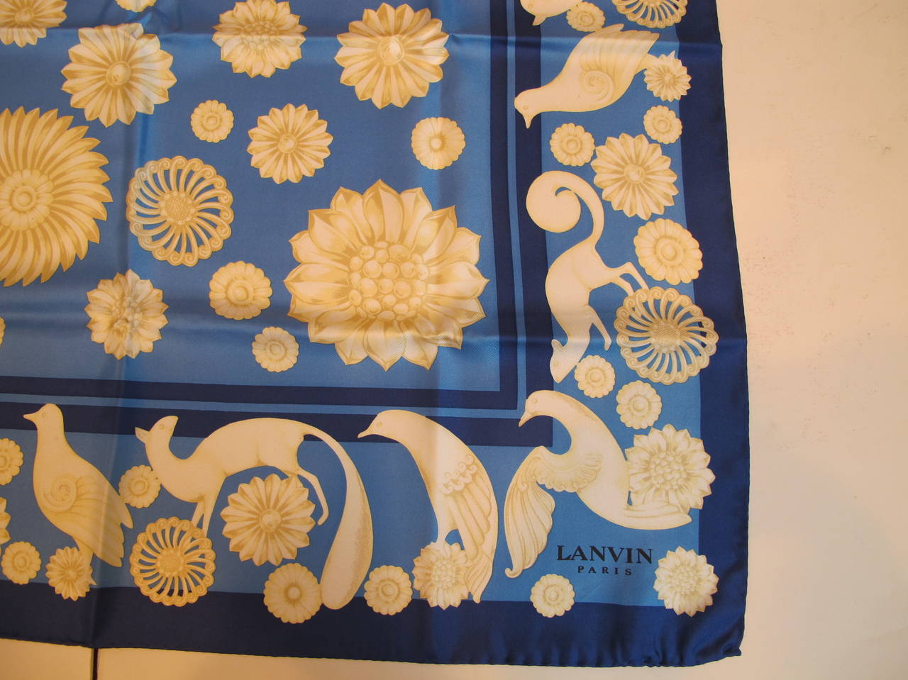 New . Vintage Lanvin Paris Silk Twill Scarf enhanced by Bird, Squirrel and Medallion motif. The colors of sapphire and azure blues give birth to an exciting scarf.