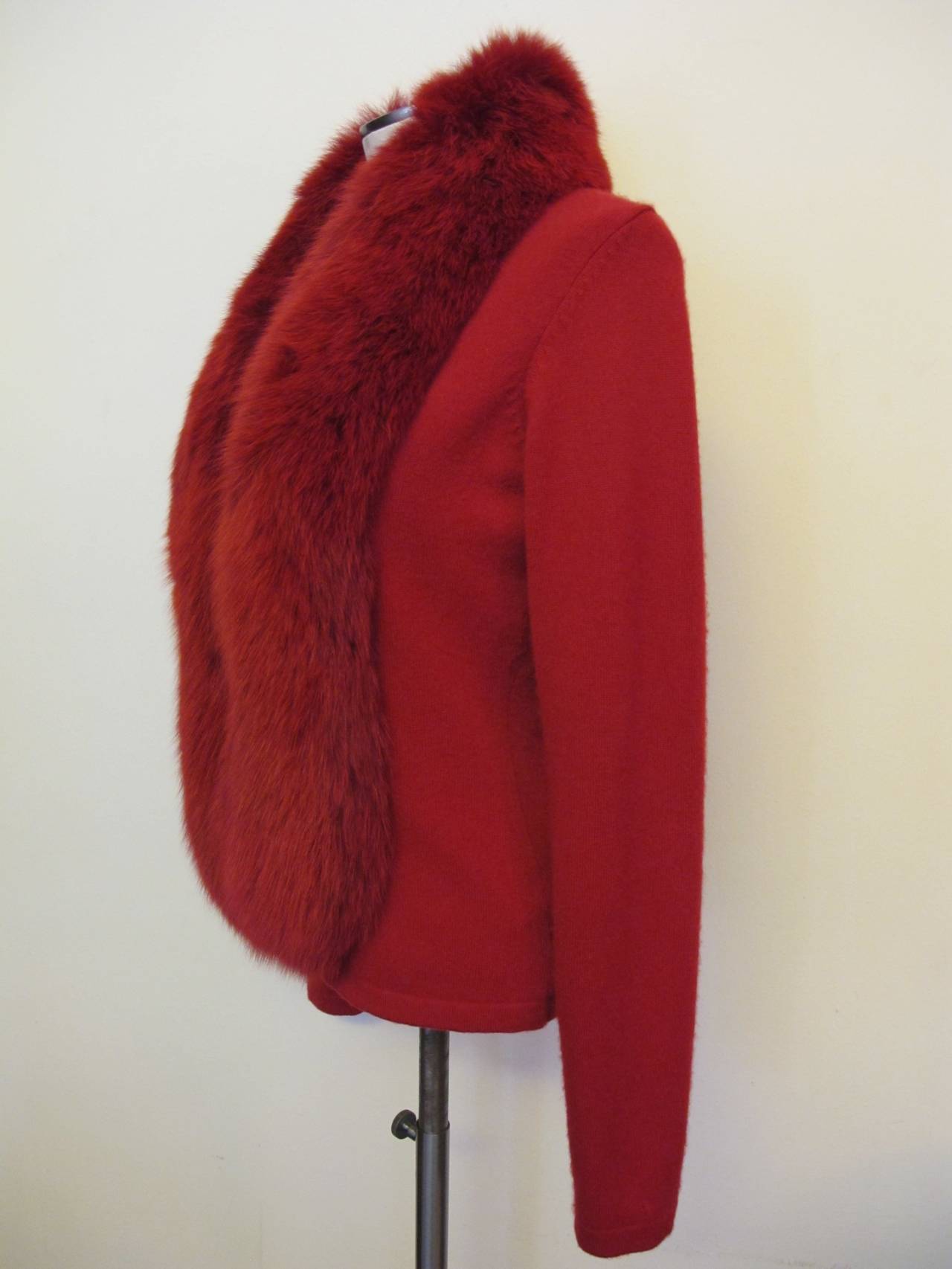 Chic, comfortable Randolph Duke Cashmere Sweater with 6 inch wide fox trim. The color of scarlet red with matching scarlet red fox trim accentuates the innate beauty and elegant style of this magnificent piece. It is perfect with jeans and as a