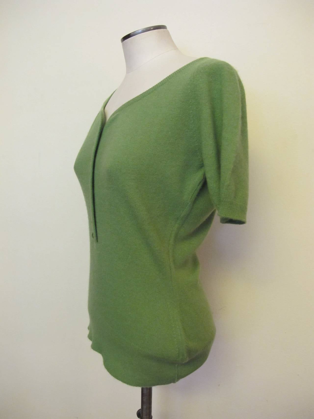 In 1951, Lyle and Scott (originally founded in Scotland in 1874) began its U.S. representation at 200 Madison Avenue, New York. In 1954, Lyle and Scott collaborated with Christian Dior. The label of this split pea green cashmere scooped neck sweater