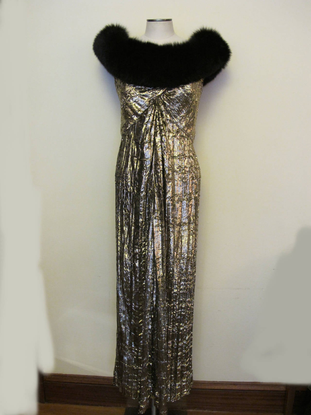 Bob Mackie's luscious gown is captured with flattened pile and the 6 inch fox collar that circles the front and back of the gown. The boning and built in bra contributes to the structure and integrity of this elegant statement piece. 1990's I.