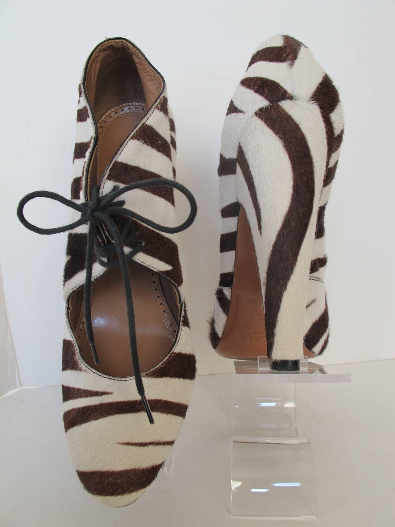 Over the top Alaia Brown Zebra Shoes with five holes to lace with black shoe strings. The heel is 5 inches high. His vision has created this masterpiece for the feet. Worn by model on runway only.