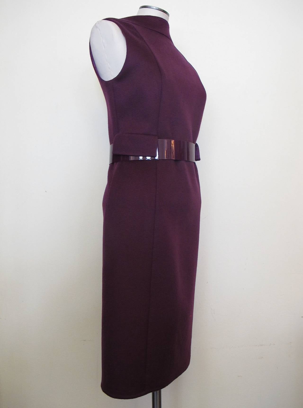 Exquisite plum cashmere dress created by the Swiss master, Albert Kriemler. The quality of the workmanship, fabrics and 100% silk lining is magnificent. The metal belt with the sued elasticized attachment creates a one of a kind look to the fashion