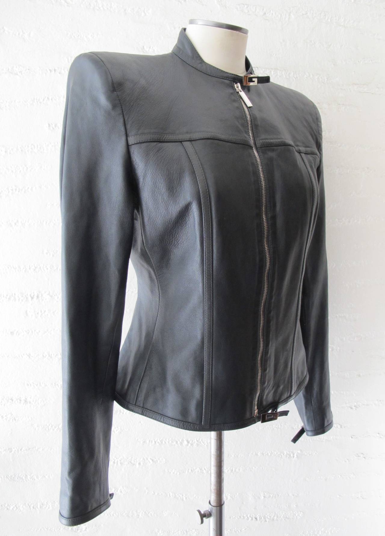 Fabulous black leather Gucci jacket designed by Tom Ford. There are 4 silver buckles with Gucci name inscribed on the silver chrome buckles which can be seen on the neck, bottom of jacket and one on each sleeve. They serve as closures. Sleeve length