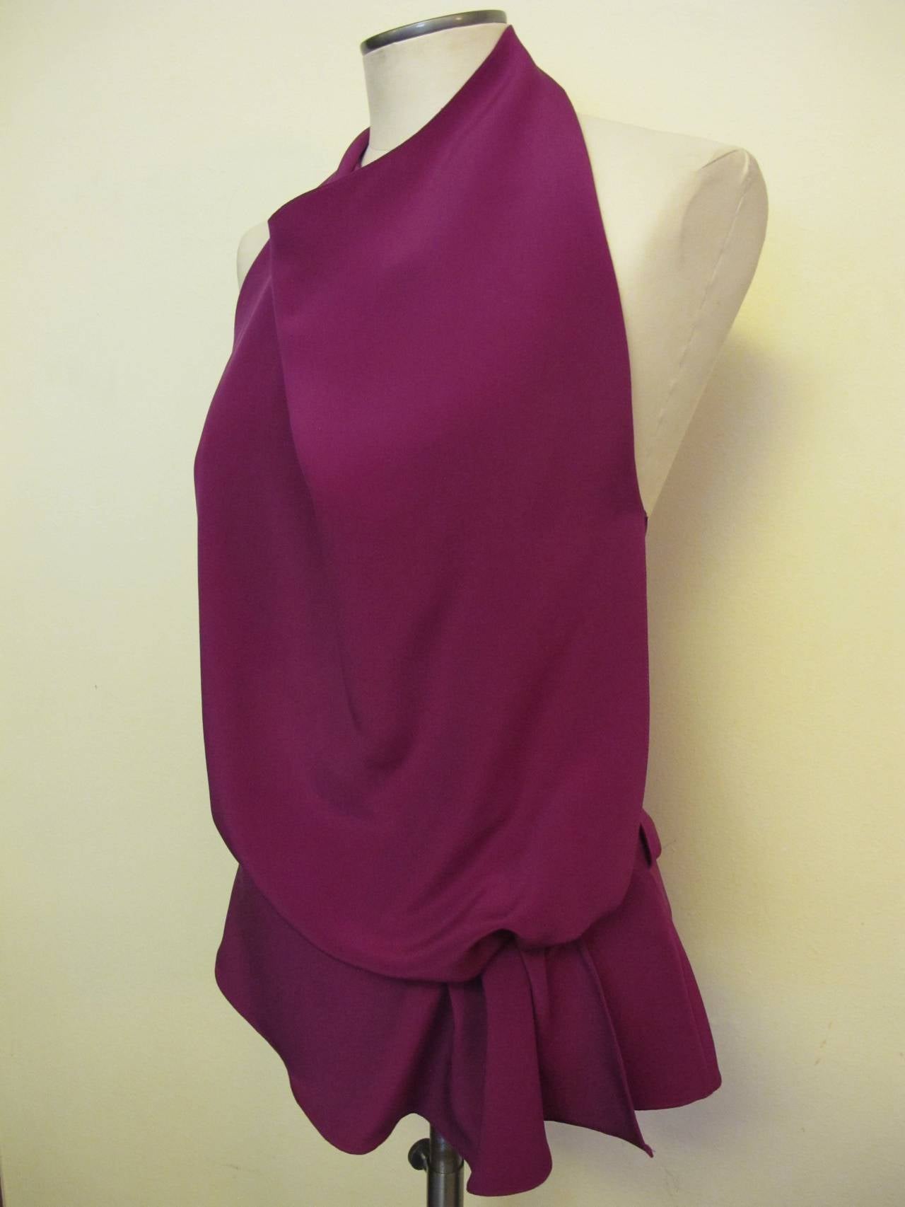 Gorgeous Tom Ford fuchsia halter silk blouse serves as day and evening wearability. The blouse is cut on the bias. It is backless and the silk fabric overlaps at the back. There is a ruffle gathered below the waist forming a drape with pleats on the