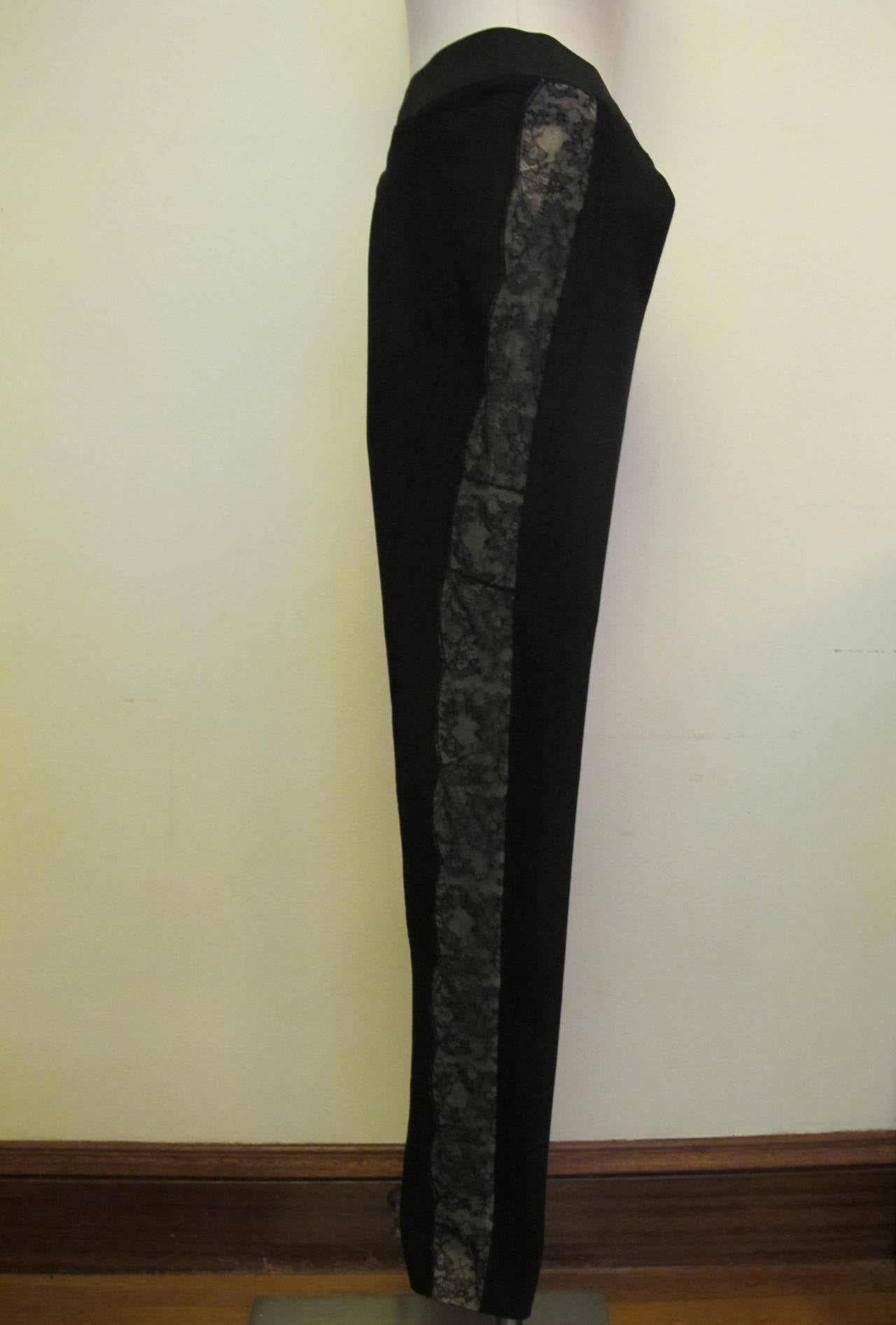 Chic new Stella McCartney black slacks with 2.25 inches width lace on sides. Lace begins at bottom of black elastic waist band. The fabric throughout stretches to contour of body.