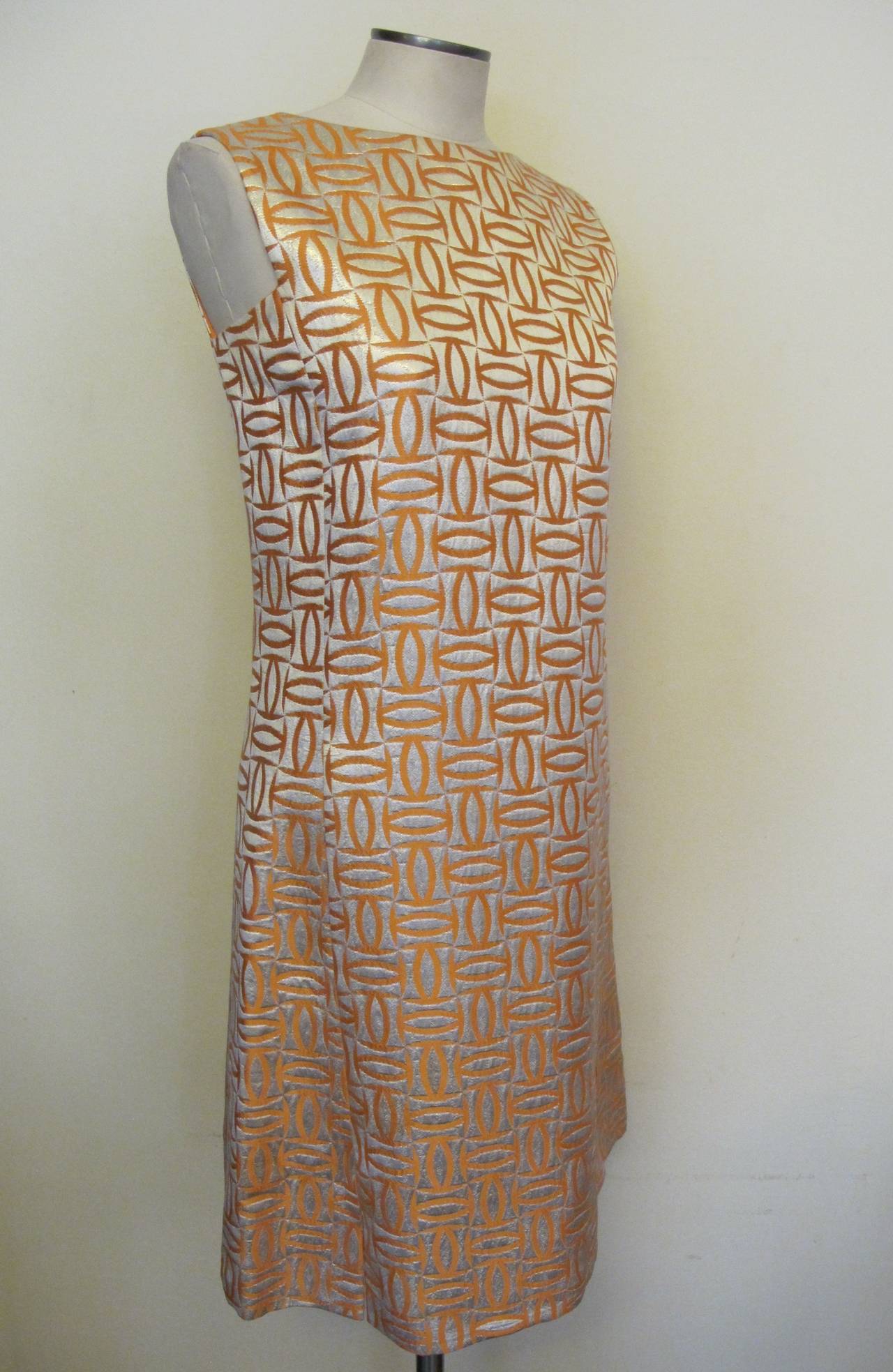 Jackie Kennedy Onasis late 1960's rich sliver and salmon sleeveless cocktail dress with tribal design Label states Best & Co. Fifth Avenue. New York. There is no Malcolm Starr label in Dress, however it matches an evening coat that is on our site