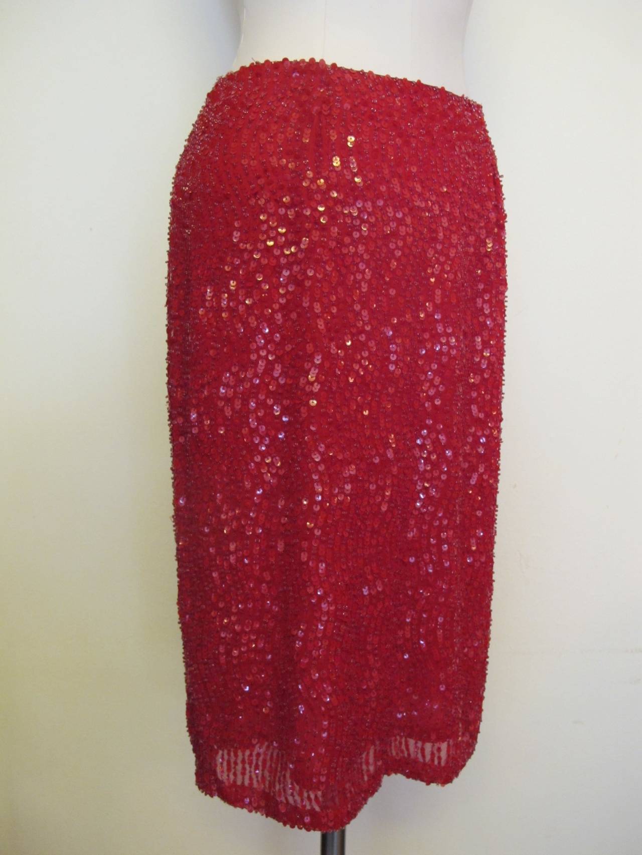 Chic red silk chiffon evening skirt totally embedded with red sequins and red beads. The fit on the body is impressive.