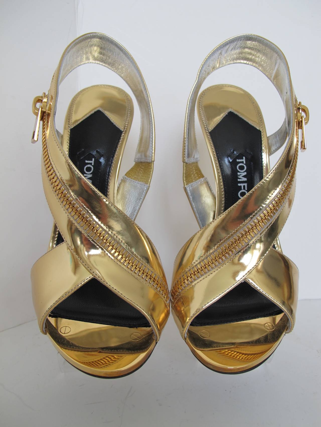 Tom Ford Gold Sling Back Sandal with Wrap Around Zipper is perfect for day or evening. There is 1.375 inch metal piece with two inset screws at the toe. Heel measures 4.5 inches.