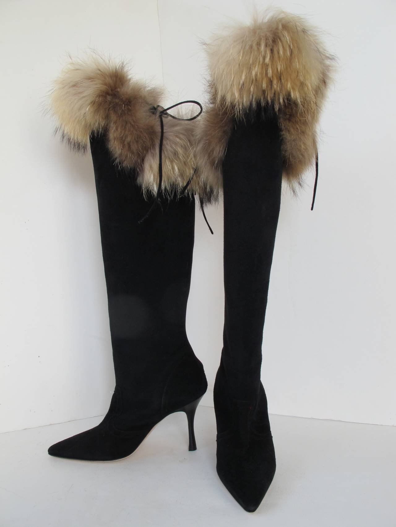Chic Manolo Blahnik Black Suede Knee High Boots with Fox Fur Trim may be worn for day or evening wear. Heel measures 4 inches. Height of the boot measures 21 inches.