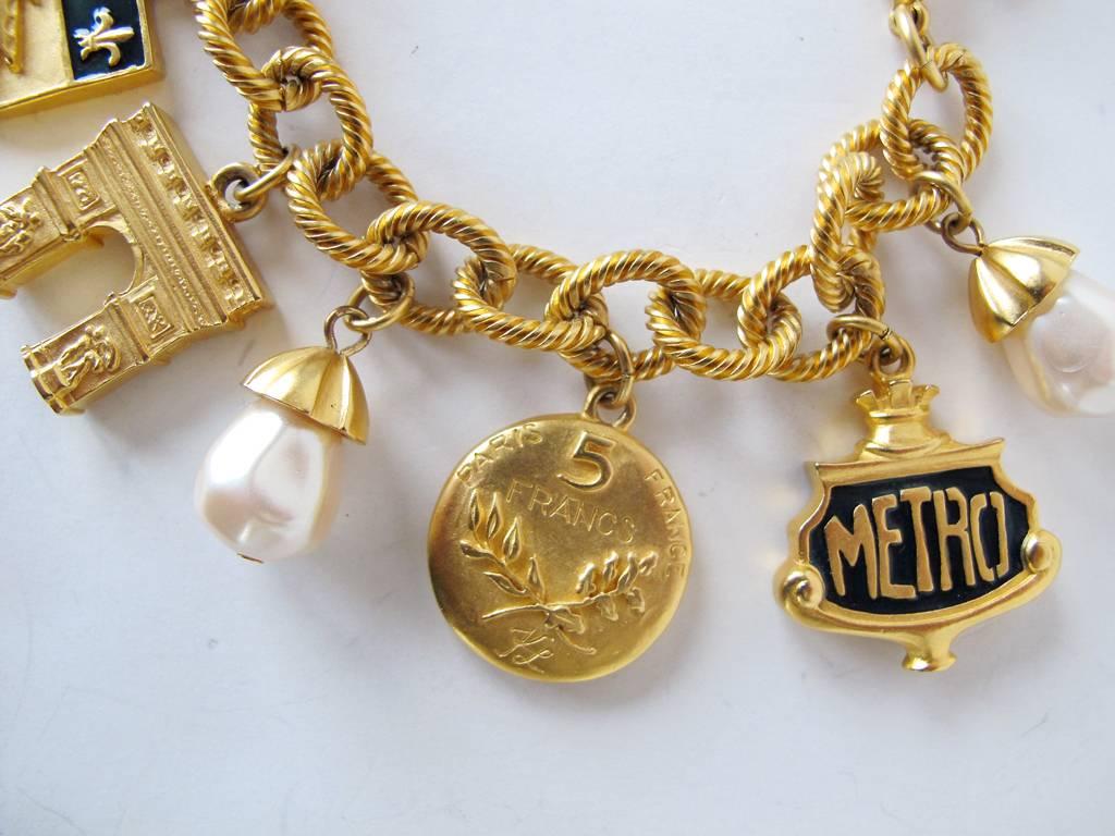 1980's Karl Lagerfeld Gold-Tone and Pearl Paris Inspired Charm Bracelet In Excellent Condition For Sale In San Francisco, CA