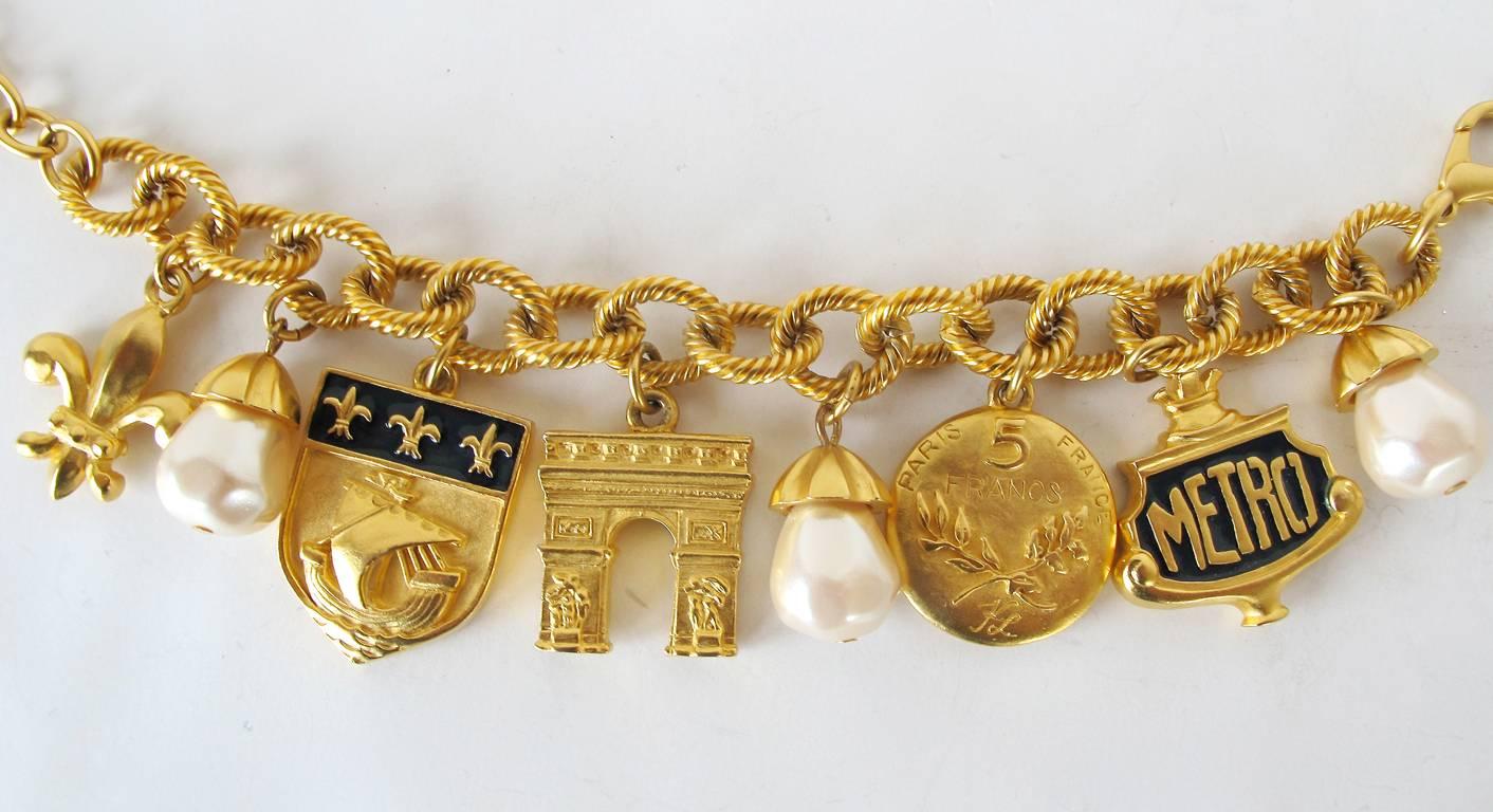 This vintage 1980's gold-tone chain link charm bracelet has lovely Paris inspired charms, including the Arc de Triomphe. There are beautiful faux pearl drops between each and every charm. The piece is in excellent condition and is 
10 inches in
