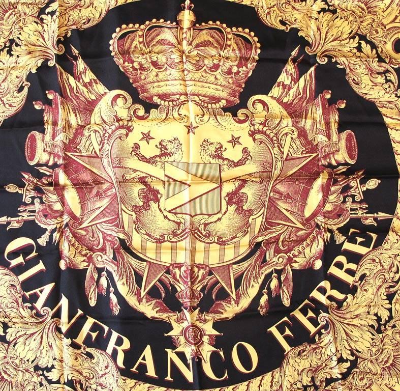 This chic Gianfranco Ferre gold, red and black royal crest scarf is 100% silk and has hand rolled edges. The border is red and gold and the royal crest in the center of the the scarf is adorned with a large crown. The scarf is 35 X 35 inches.