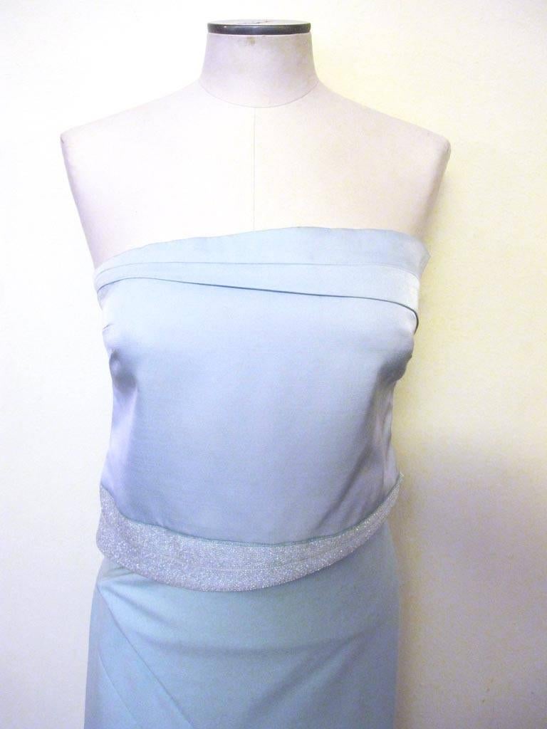This gown is a favorite of Helpers. The color blue is soft and the two pieces hug the body is an ethereal manner. Along the bottom of the bodice there is a 2.75 inch ice blue beaded angular design. There is a three dimensional geometric seamed