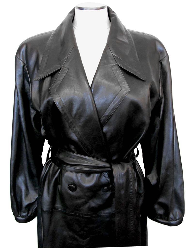 This 1980's oversized, drop shoulder Yves Saint Laurent black leather trench coat has a notch collar and 2.5 inch matching belt. It is double-breasted and large 1¼ leather piping adorns the wrists.

Size: 16-18
Shoulder to shoulder: 21