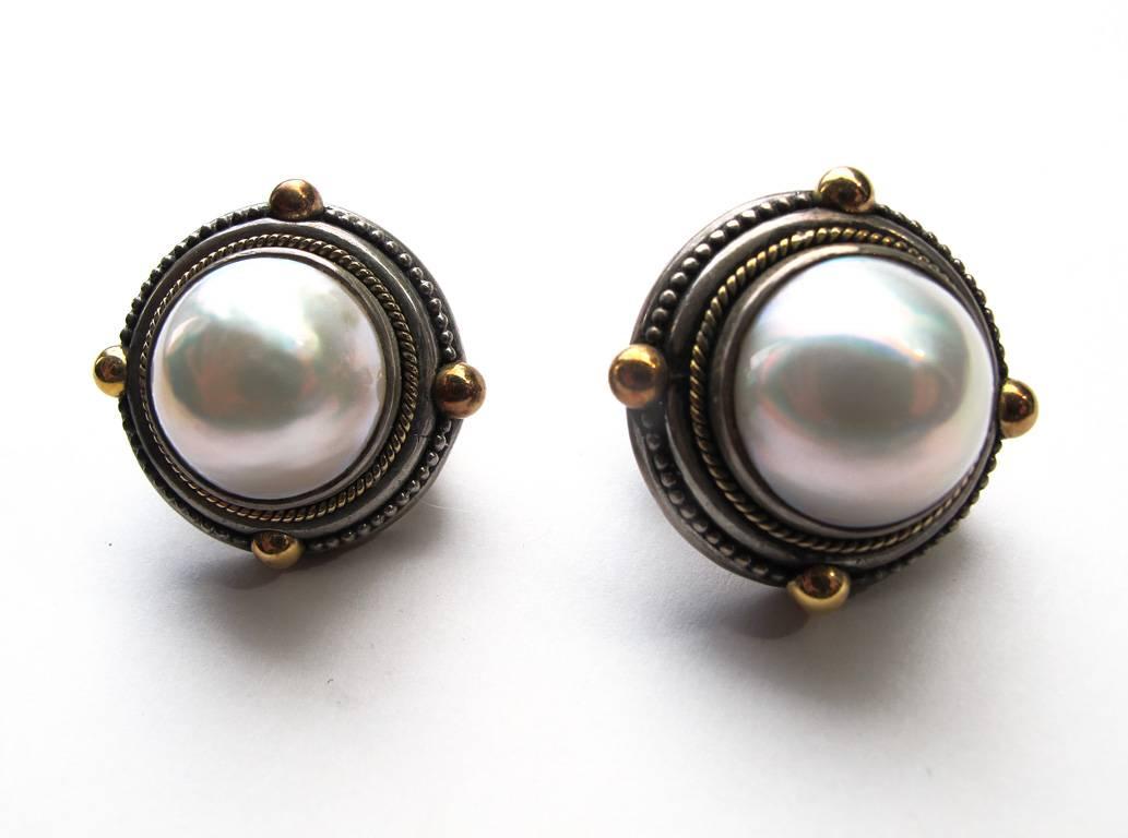 Vintage 1980's Mabe pearl clip earrings in a sterling silver setting with bronze accents. They are by renowned Brooklyn-based jewelry designer Stephen Dweck. Signed.

YOUR PURCHASE BENEFITS THOSE WHO ARE DEVELOPMENTALLY DISABLED.