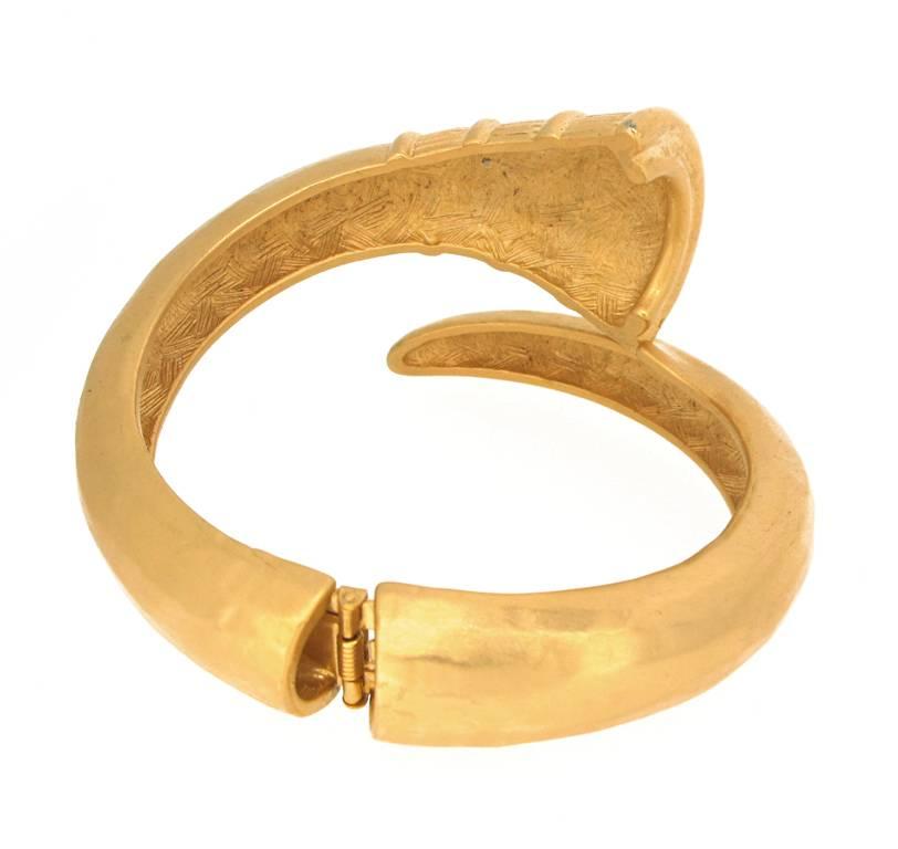Vintage 1980's Givenchy gold plated French horn hinged bracelet. This bracelet fits a wrist size 6