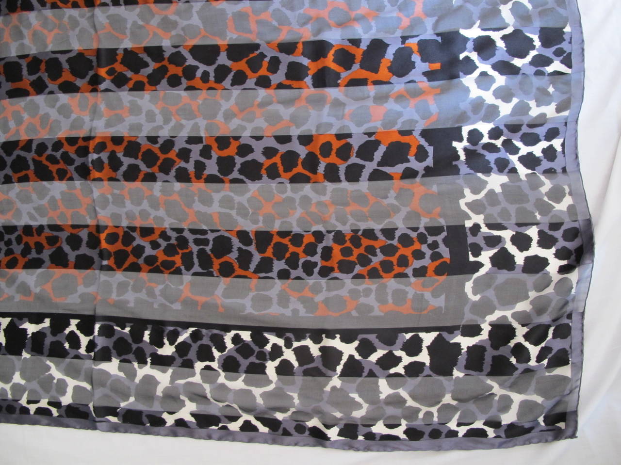 Luxurious oversized leopard designed silk scarf-shawl. Colors include vicuna, black, grey and white and is hand-rolled. Also can be used as a pareo.