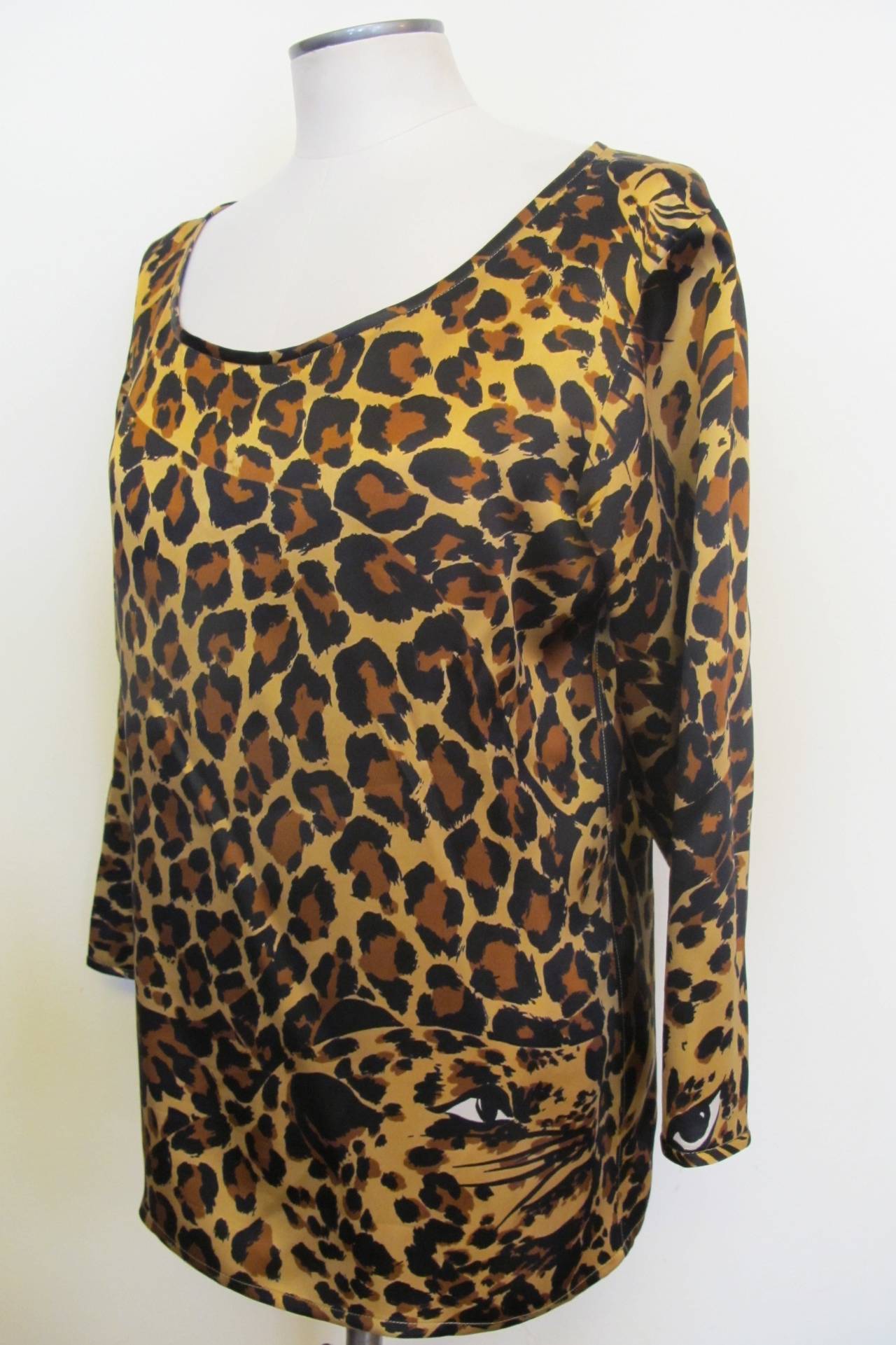 Iconic Saint Laurent Rive Gauche lower scooped neck blouse created from Saint Laurent's leopard silk. It is so chic, when on the body. Size Medium to Large. Sleeve length measures 19.25 inches. Shoulder to shoulder measures 16 inches.