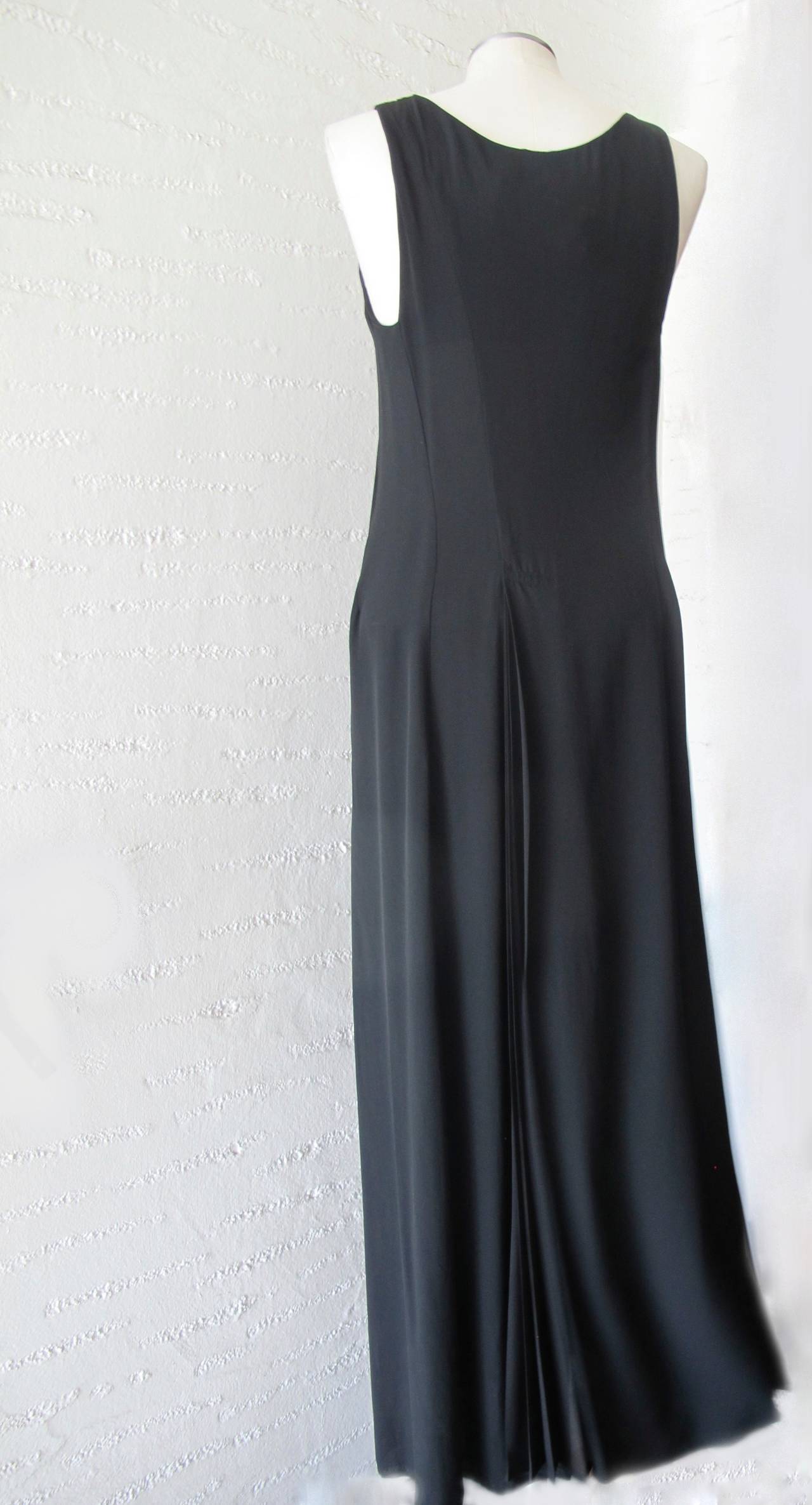 Elegant, sleeveless iconic Yohji Yamamoto long dress. There are 32 inch silk pleats in the back and in the front of the long black dress with two pockets at the hips. Donated by Wilkes Bashford, San Francisco with Wilkes Store Tag. Shoulder to