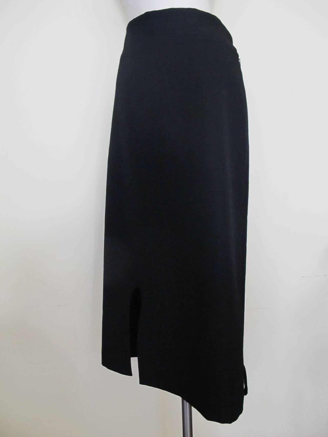 Yohji Yamamoto Black Wool Skirt is perfect for day or evening. The waist band measures 2.25 inches and there is a 9.5 inch slit on the bottom right side of the skirt. It is part of the collection of the the former Fashion Director of Saks Fifth