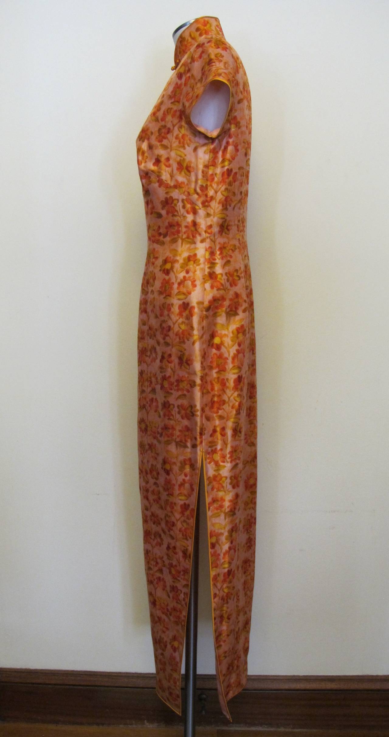 This stunning Qipao Salmon Silk Dress which is fully lined was donated to Helpers by the Fashion Director of Saks Fifth Avenue. It is new and has never been worn. It is perfect for Summer season with short sleeves and golden yellow silk satin