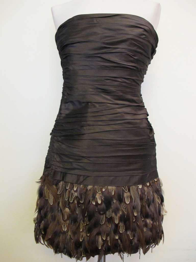 Fabulous brown silk taffeta strapless cocktail dress with horizontal pleating. Lined in high quality brown silk taffeta. 9 inch feather layer with dark bronze. Pleated section 17 inches long.