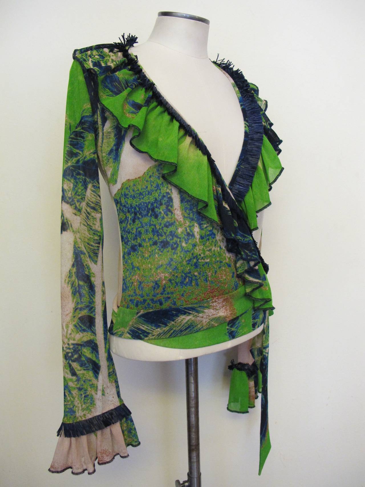 Fabulous wrap around Blouse with lush colors of royal blue and neon green. Palm trees can be seen in back. Sleeve length measures 26 inches.