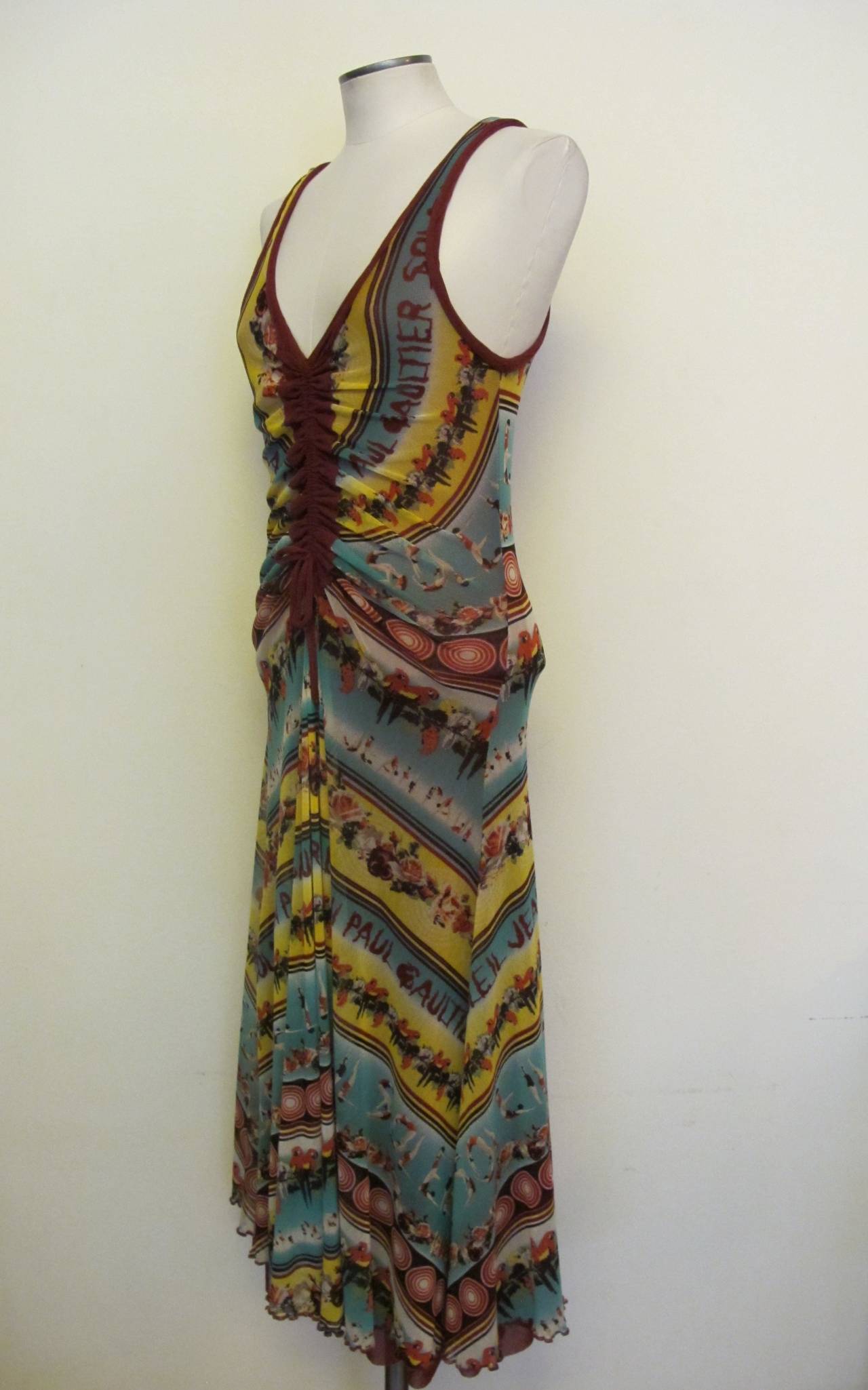 Collectable Jean Paul Gaultier Soleil Dress with a variety of motifs: Parrots, circular archery targets, band of roses, Soleil and Jean Paul Gaultier  are spelled out with ballerinas. Colors are yellow, turquoise, maroon and black. Bust measures 27