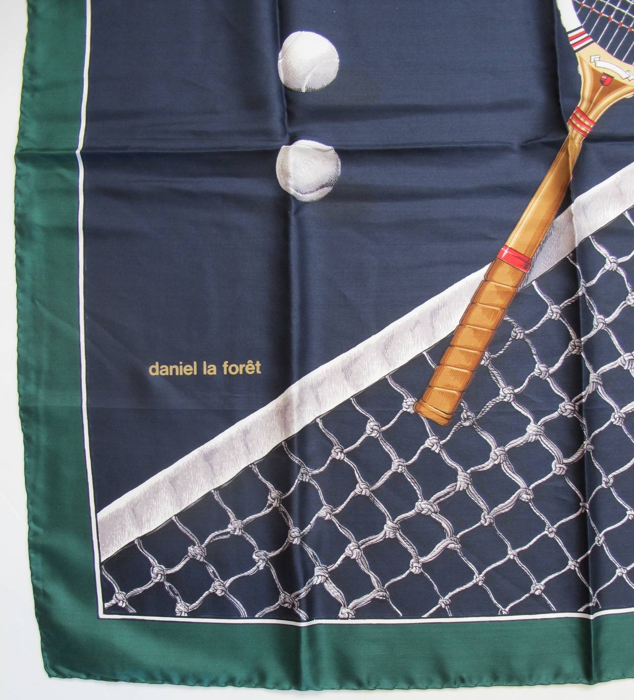 Clever silk scarf which captivates the Tennis World. Design includes net, racket and balls. The hem is hand rolled.