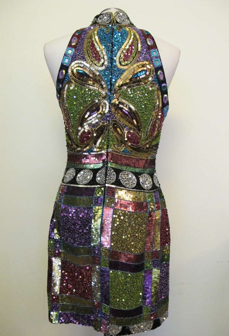 Show-Stopper beaded sequined cocktail dress donated to Helpers Charity by a well known Grande Dame. Threaded oval and squared shaped reflectors enhance the art of this collectable piece. A line Design. Label states Naeem Khan Riazee Nights. Filled